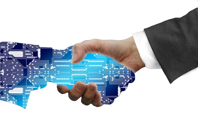 Illustration of a human hand in a business suit shaking hands with a robotic hand, representing the collaboration between healthcare professionals and AI technology in enhancing Revenue Management through automation of tasks like claim scrubbing, eligibility verification, and denial management