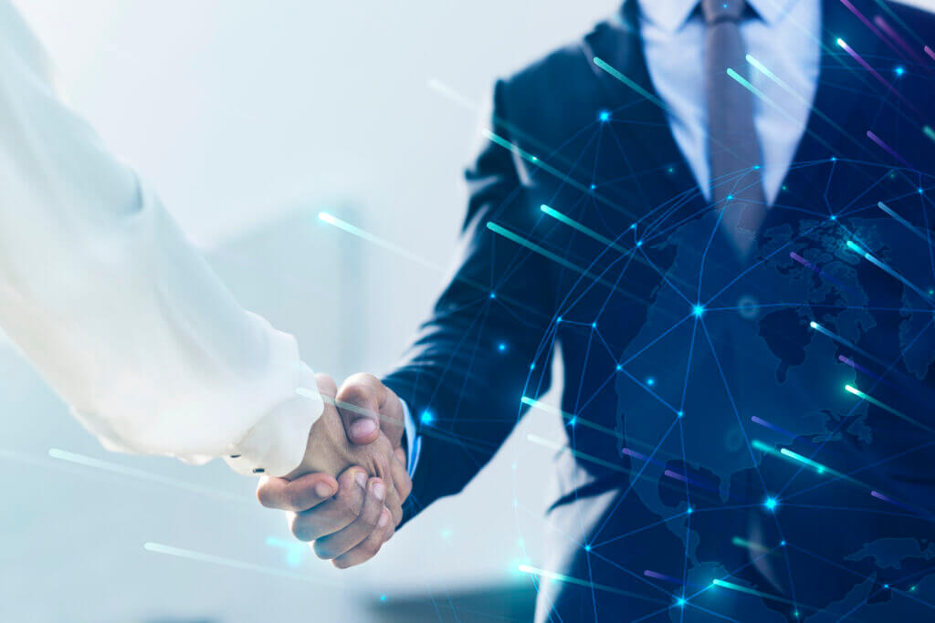 A firm handshake between healthcare professionals overlayed with a digital network globe, representing RSB Healthcare Consulting’s commitment to providing advanced medical billing services and global technological solutions