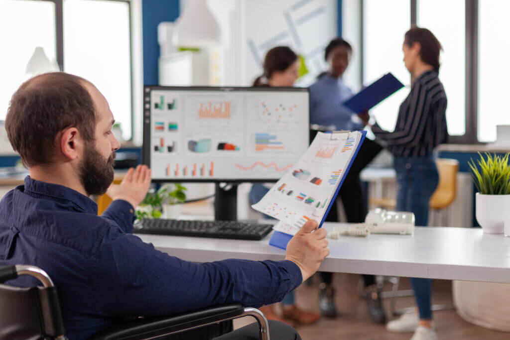 Healthcare professionals engaged in a strategic meeting to address the challenges of revenue forecasting in the healthcare industry, using computer and whiteboard analytics to integrate diverse data sources for accurate financial projections