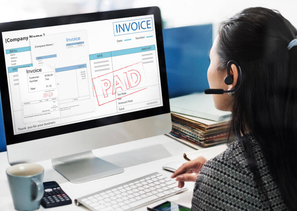 Close-up of an invoice with a 'Paid' stamp, representing financial transaction and account management.