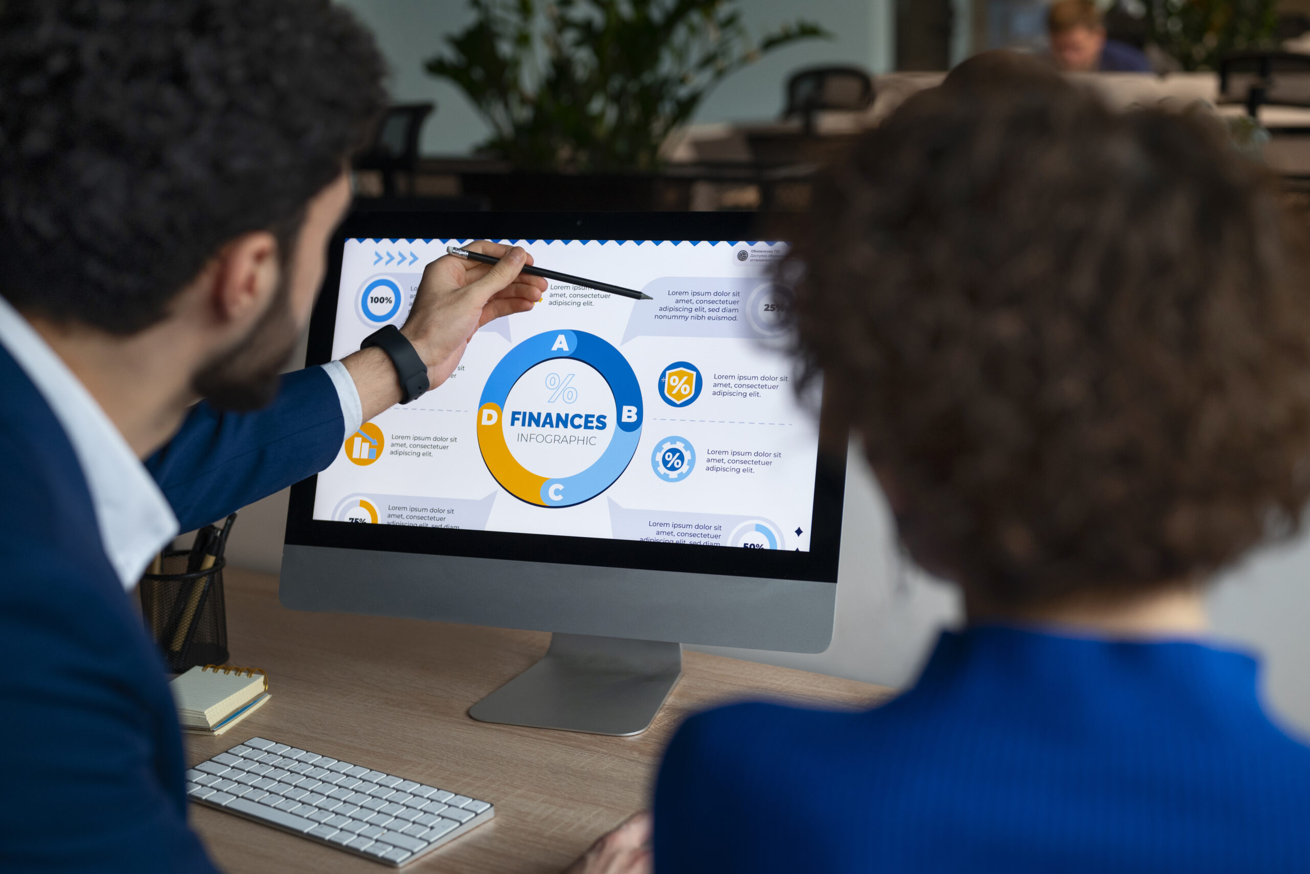 Two professionals analyzing advanced revenue forecasting models on a computer screen, showcasing statistical charts and graphs pertinent to healthcare financial planning