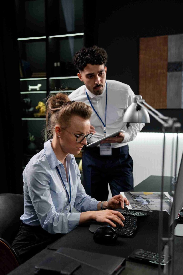 Three professionals working on medical coding and audit in an office setting.