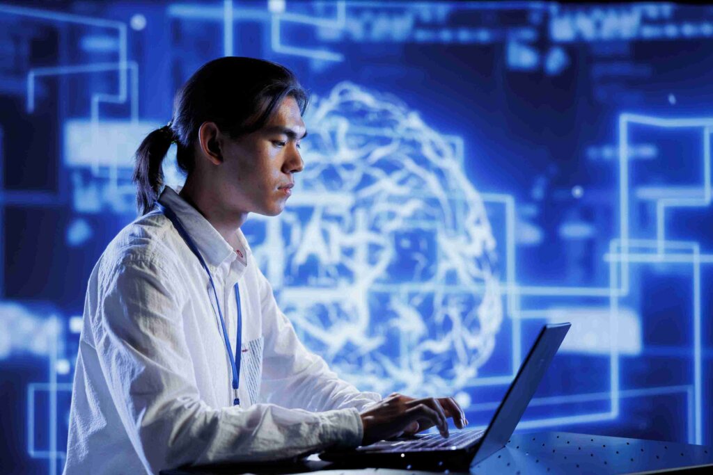 A medical professional working on a laptop with digital graphics of brain and coding elements in the background, symbolizing medical coding and audit.